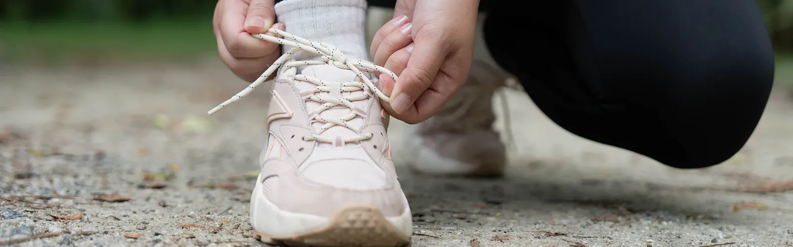 A runner tying her shoes